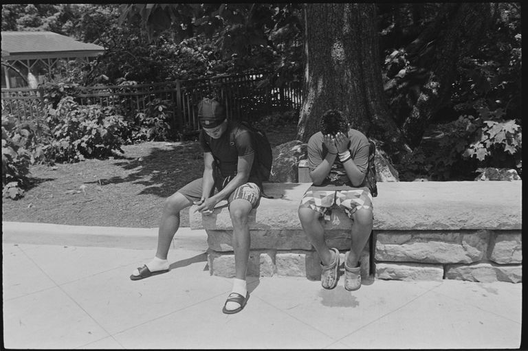 two kids sitting in the sun